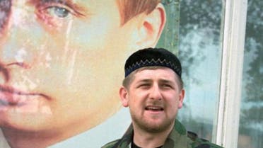 Chechen leader Ramzan Kadyrov poses by a picture of his backer, Russian President Vladimir Putin. (File photo: AFP)