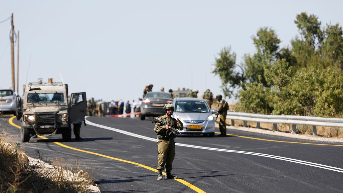 Israeli soldiers secure the scene of a shooting attack near Hebron, West Bank, Friday, July 1, 2016. (AP)