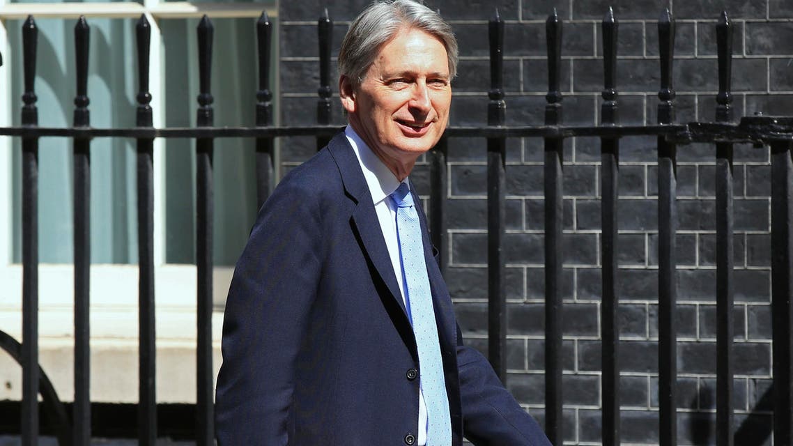 Hammond said the government was taking steps to rehire former civil servants who have trade negotiating skills. (AP)