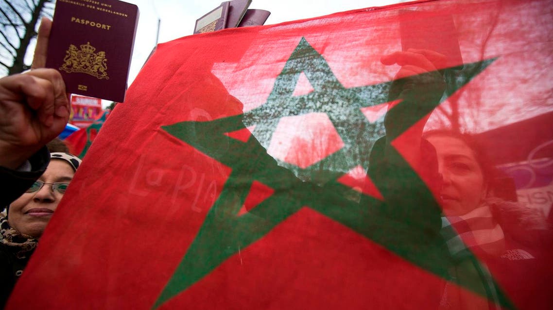 Protesters hold a Moroccan national flag during a protest against Geert Wilders, leader of the Dutch hard-right Freedom Party, in Amsterdam March 22, 2014. A parliamentarian for the Freedom Party resigned from the party on Thursday amid uproar over the way leader Wilders led supporters in racist chants against Moroccans during an election night rally. Wilders' eurosceptic, anti-Islam Freedom Party failed to make the huge gains it had expected in Wednesday's municipal elections, which it contested in two cities. REUTERS