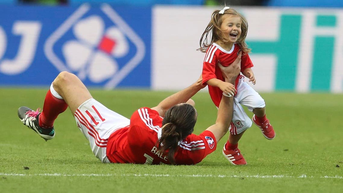 Wales' Gareth Bale celebrates with his daughter Alba after winning the Euro 2016 round of 16 soccer match between Wales and Northern Ireland, at the Parc des Princes stadium in Paris, Saturday, June 25, 2016. Wales beat Northern Ireland 1-0. (AP Photo/Petr David Josek)