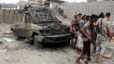 Armed Yemeni men stand next to destroyed vehicles after Yemeni government forces supported by a Saudi-led coalition recaptured an army headquarters near Aden airport from suspected militant after an hours-long firefight on July 6, 2016 in the southern city (Photo: AFP)