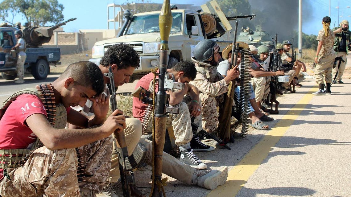 Soldiers from forces aligned with Libya's new unity government are seen resting on the road during an advance on the Islamic State stronghold of Sirte, June 8, 2016. REUTERS