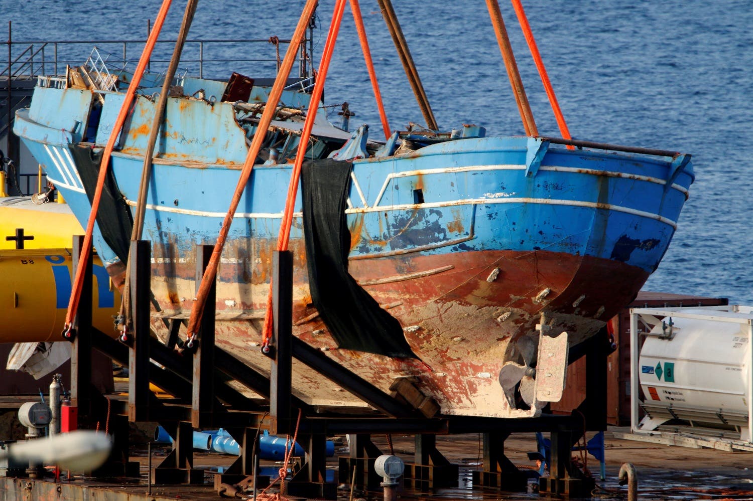 The wreck of a fishing boat that sank in April 2015, drowning hundreds of migrants packed on board, is seen after being raised in the Sicilian harbour of Augusta, Italy, July 1, 2016. REUTERS
