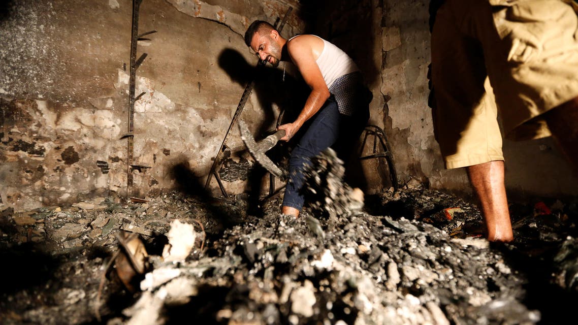 People search for their relatives at a site after a suicide bomb attack at the shopping area of Karrada, a largely Shi'ite district, in Baghdad, Iraq July 4, 2016. (Reuters)