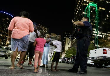Dallas police order people away from the area after several police were shot in downtown Dallas, Thursday, July 7, 2016. (AP)