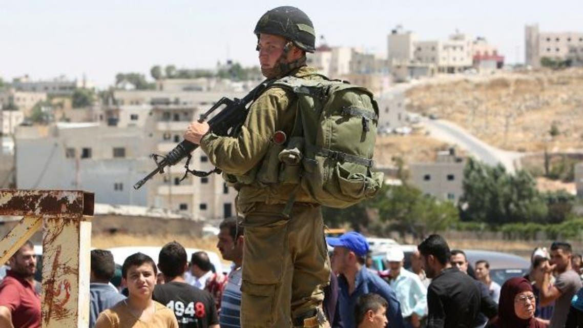 Israeli soldiers stand guard during the funeral procession of Israeli Michael Mark, who was killed on July 1 after his car was fired on by a suspected Palestinian gunman. (AFP)