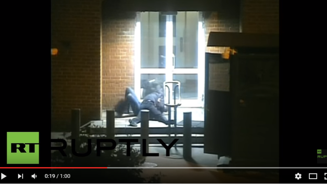 The CCTV footage shows a man in police uniform grab and wrestle the diplomat to the floor about two meters from the door leading into the embassy building. (Youtube)