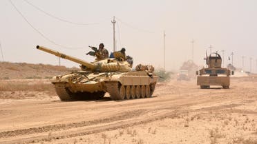 Iraqi government forces drive a tank on June 22, 2016 some 40 kilometers west of Qayyarah, during their operation to take the city and make it a launchpad for Mosul. (AFP)