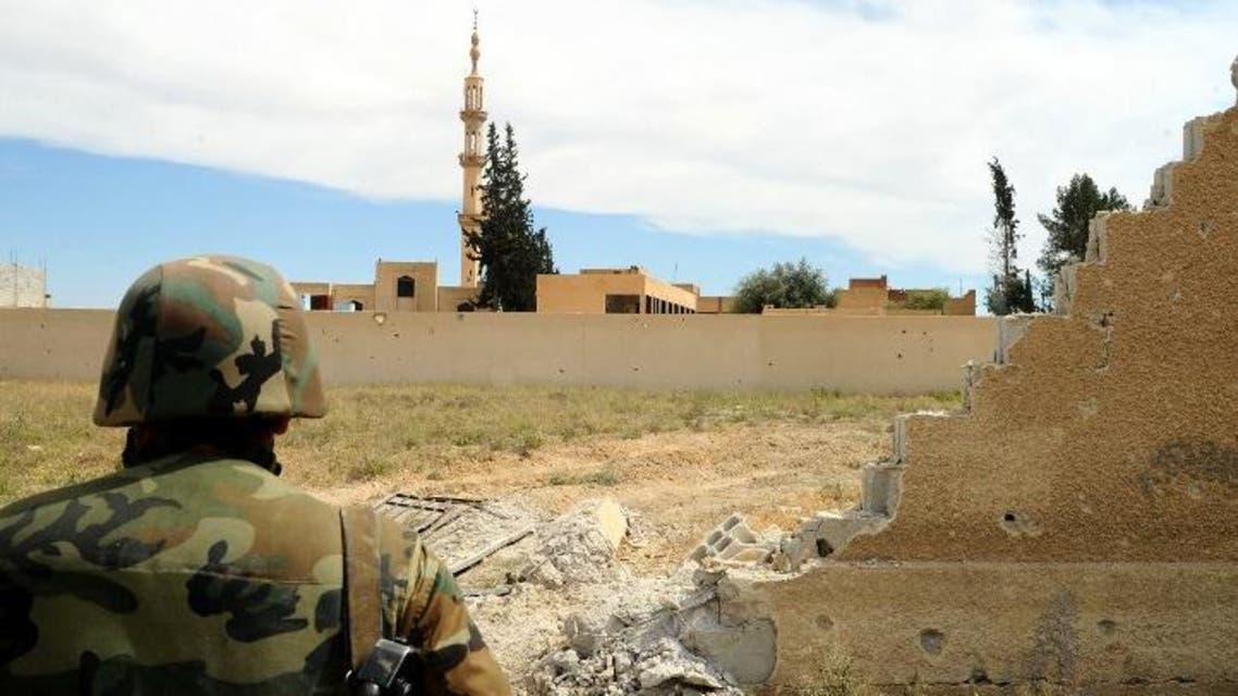 A handout picture released by the Syrian Arab News Agency (SANA) on May 3, 2015 shows a Syrian pro-government fighter keeping position in the village of Maydaa in rural Damascus. (AFP)