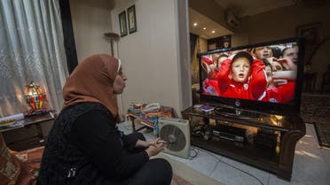 Football analyst Manar Sarhan watches the Euro 2016 quarter-final between Wales and Belgium at her home in the Egyptian capital Cairo. (AFP)