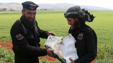 Nusra Front policemen, operating under a coalition of rebel groups called "Jaish al Fateh", also known as "Army of Fatah" (Conquest Army), carry the remnants of an explosive device that was found on the edge of a road linking Idlib to Armanaz area, Syria April 14, 2016. 