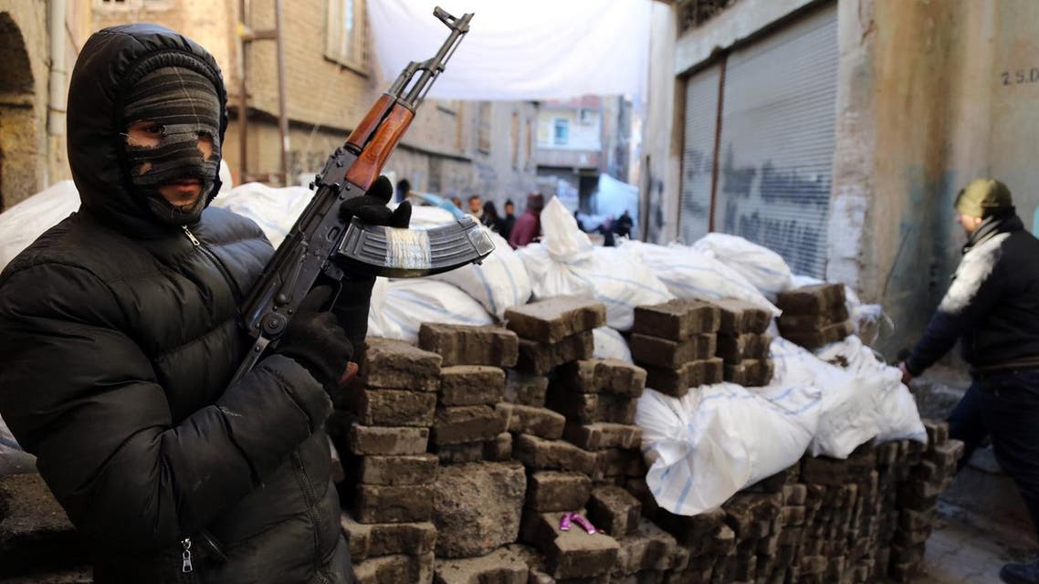 A PKK militant stands at a barricade as some of thousands of people flee from the historic Sur district of the mainly-Kurdish city of Diyarbakir, Turkey, (File Photo: AP)