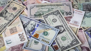 International currencies scrambled randomly ontop of each other.  (Shutterstock)