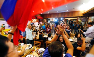 Filipinos applaud after the Hague-based U.N. international arbitration tribunal ruled in favor of the Philippines in its case against China on the dispute in South China Sea Tuesday, July 12, 2016. (AP)
