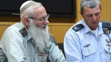 Rabbi Col. Eyal Karim (left), who has been nominated to be the Israeli military's next chief rabbi, sits next to outgoing chief rabbi Brig. Gen. Rafi Peretz, on April 21, 2016 (Photo courtesy Israeli Defense Ministry)