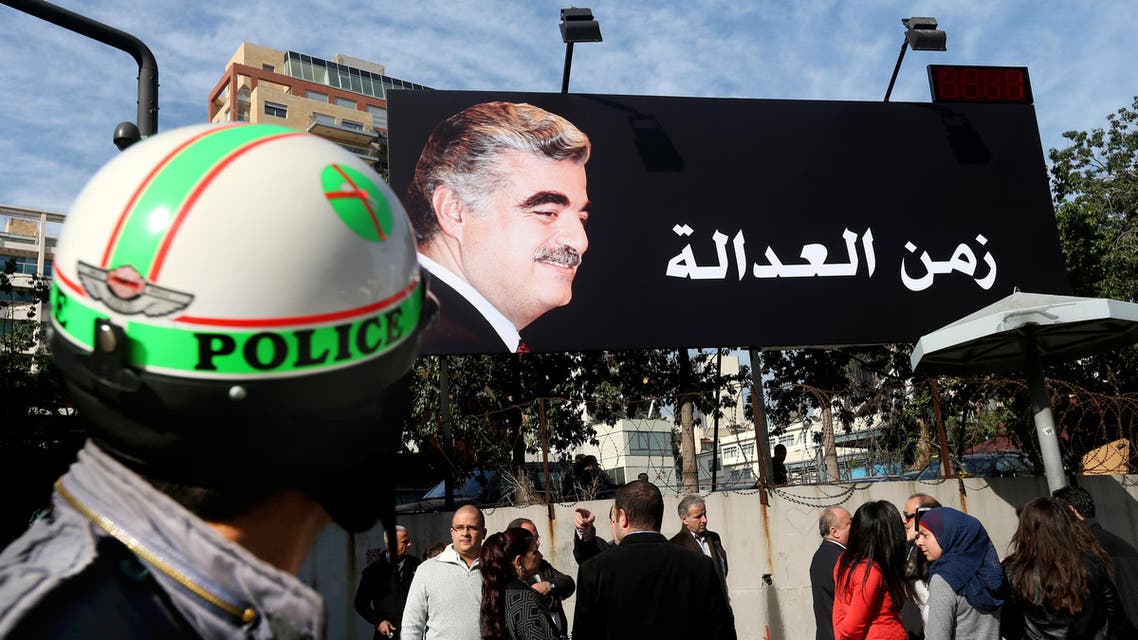 Supporters of slain former Lebanese Prime Minister Rafik Hariri, gather under a giant billboard with his portrait and Arabic that reads, "Justice," in Beirut, Lebanon, Thursday, Jan. 16, 2014. (AP)