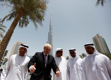 London Mayor Boris Johnson (2nd L) gestures as he arrives for a photo opportunity at Burj Khalifa boulevard in downtown Dubai, during his visit to the Emirate April 16, 2013. (Reuters)