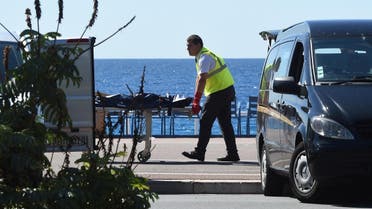 A forensic expert evacuates a dead body, unconfired if attacker or victim's, on the Promenade des Anglais seafront in the French Riviera city of Nice. (AFP)