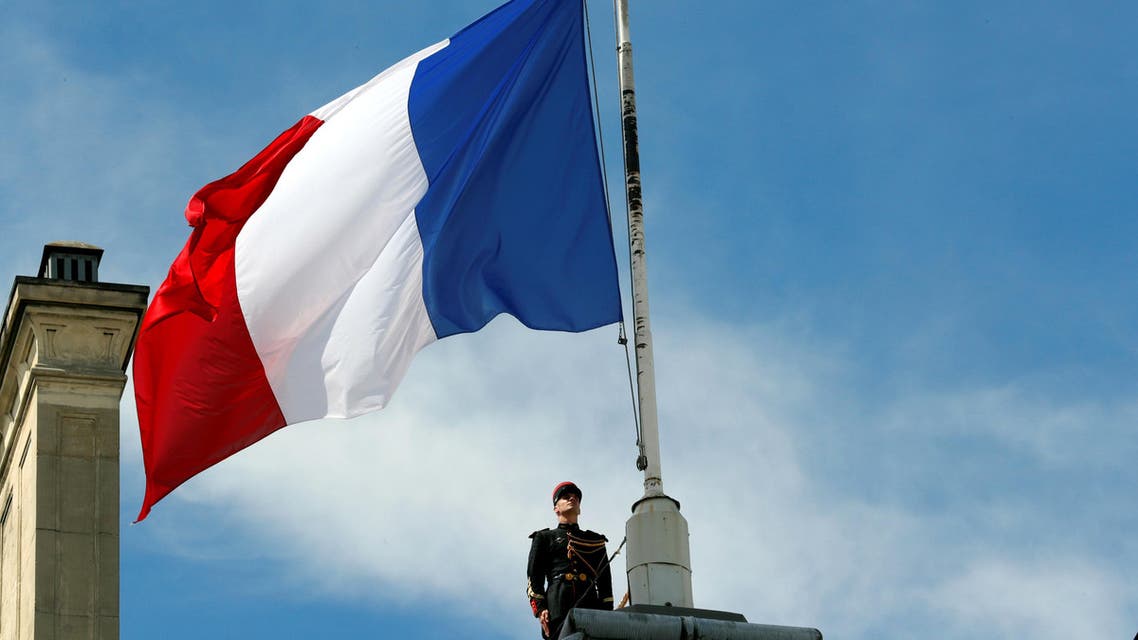 A Republican Guard pays his respects after lowering the French national flag at half-mast at the Elysee Palace in Paris. (Reuters)