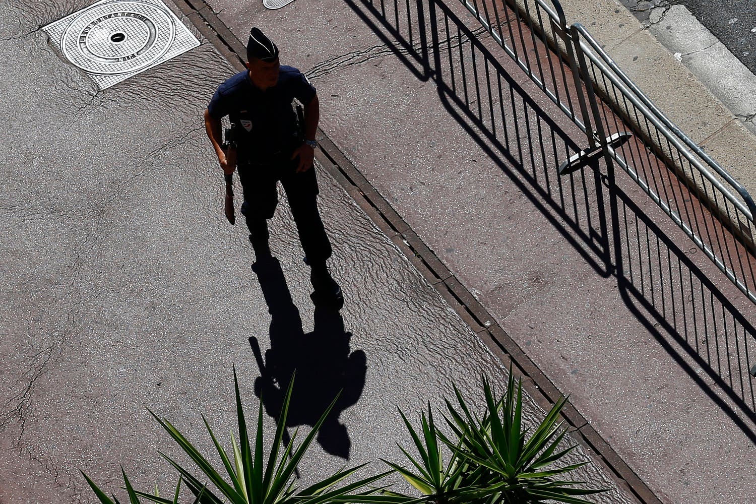 A police officer patrols at the scene where a truck mowed through revelers in Nice, southern France, Friday, July 15, 2016 (Photo: AP)