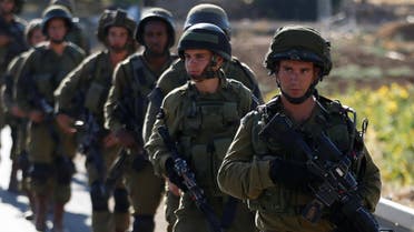Israeli soldiers provide security during a protest against the killing of two settlers by Palestinians in two separate attacks, near the Jewish settlement of Otniel in the West Bank, July 10, 2016. (File Photo Reuters)