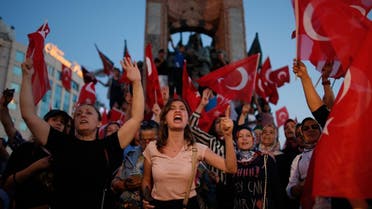 People chant slogans as they gather at a pro-government rally in central Istanbul's Taksim square, Saturday, July 16, 2016. Forces loyal to Turkish President Recep Tayyip Erdogan quashed a coup attempt in a night of explosions, air battles and gunfire that left some hundreds of people dead and scores of others wounded Saturday. (AP Photo/Emrah Gurel)