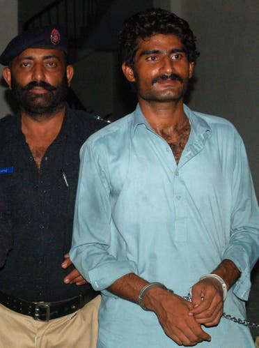Wasim (R), the brother of slain social media celebrity Qandeel Baloch, is escorted by police following his arrest for Qandeel's death in Multan. (AFP)