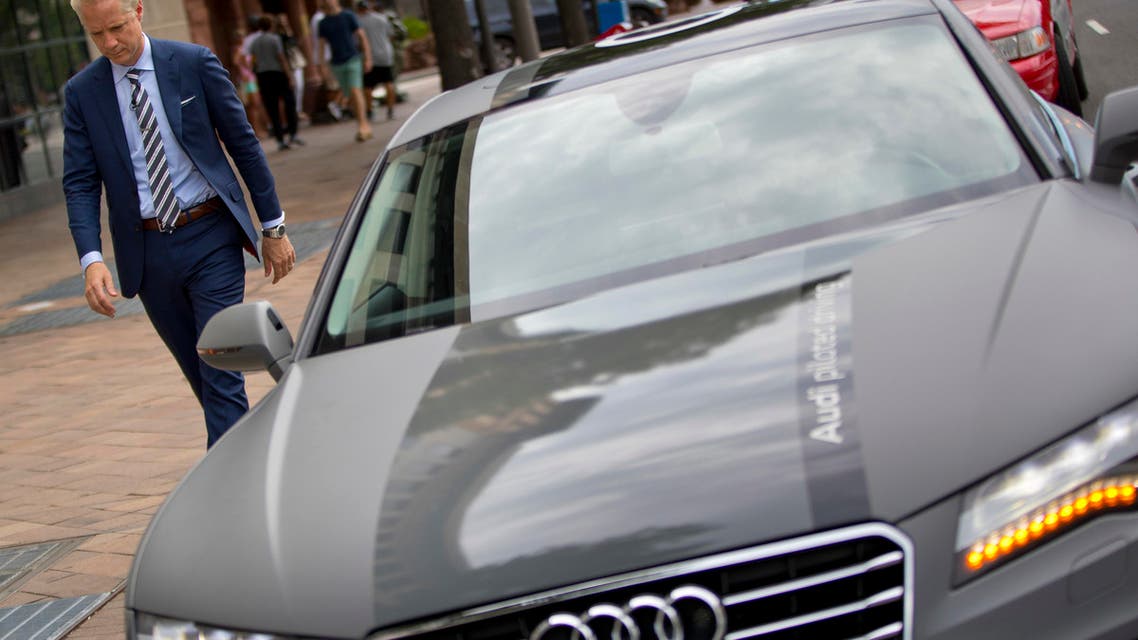 cott Keogh President of Audi of America, walks past an Audi self driving vehicle parked on Pennsylvania Ave., near the Capitol Building in Washington, Friday, July 15, 2016. (AP)