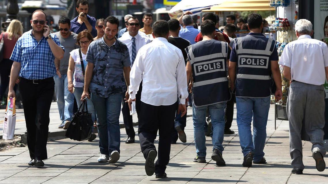 Turkish civil policemen, right, patrol between people outside the courthouse where prosecutors are questioning military personnel regarding the failed coup attempt (File Photo: AP)