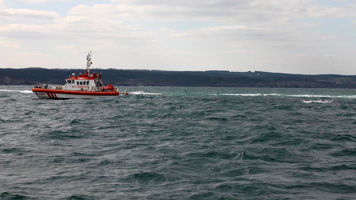 A Turkish coastguard boat searches near the remains of a boat carrying suspected migrants from Afghanistan and Syria that sank just north of the Bosphorus Strait off the coast of Istanbul, Turkey, Monday, Nov. 3, 2014, leaving at least 24 people dead and several people missing. Seven people were rescued, Turkish authorities said.(AP Photo)