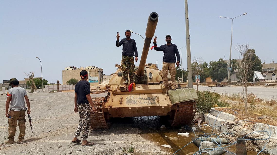 Members of the Libyan pro-government forces gesture as they stand on a tank in Benghazi, Libya, May 21, 2015. (Reuters)