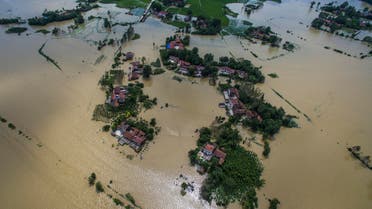 This Wednesday, July, 20, 2016 photo released by Xinhua News Agency, shows village houses and field partially submerged by flood waters in Gaoyang Town, Shayang County, central China's Hubei Province. China says dozens of people have died or gone missing since Monday in massive floods across the country's north. (Xiao Yijiu/Xinhua via AP)