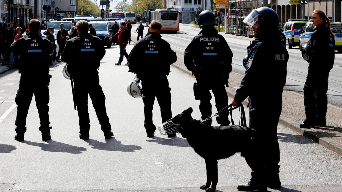 German police officers guard a bar with Eintracht supporters in the city center in Darmstadt, Germany, Saturday, April 30, 2016. (AP)
