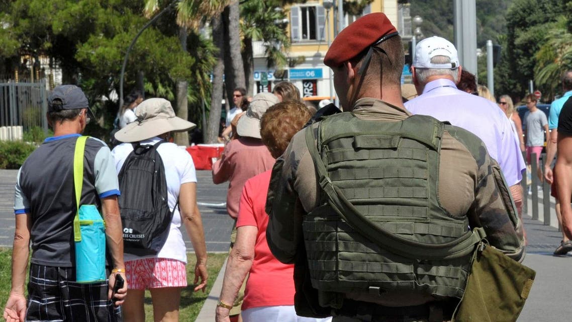 An armed French paratrooper patrols the street to maintain security after French lawmakers approved a six-month extension of emergency rule within France, in Nice July 21, 2016. REUTERS