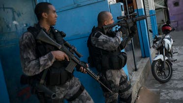 Officers take positions during a police operation against drug traffickers at the Jacarezinho slum in Rio de Janeiro, Brazil, Wednesday, June 29, 2016. Recent violence is adding to worries about safety in Rio during the Olympics. Officials have warned that budget shortfalls may compromise security during the games. (AP)