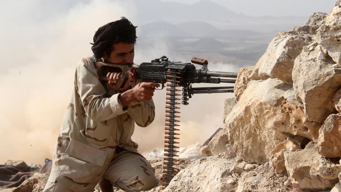 A Yemeni tribesman from the Popular Resistance Committees, supporting forces loyal to Yemen's Saudi-backed President, aims his weapon as he holds a position during fighting against Shiite Huthi rebels and their allies on June 27, 2016, in Hilan mountains, west of Marib city. AFP