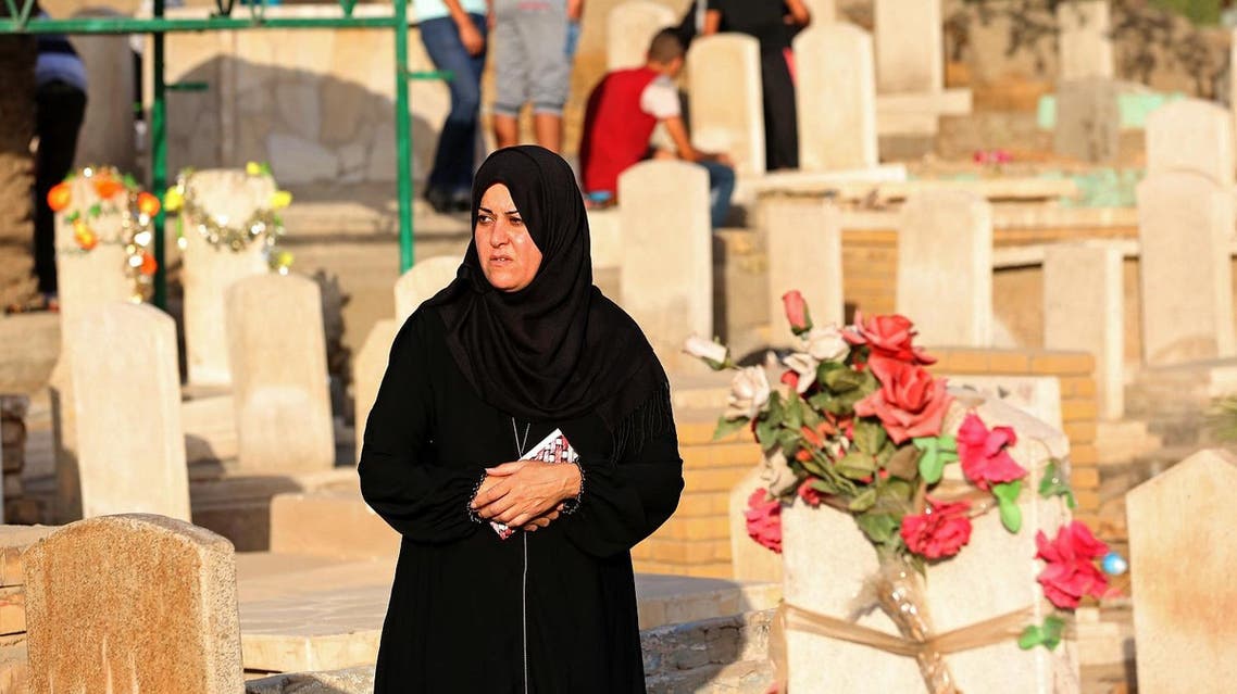 Iraqis visit the graves of their relatives during the first day of the Muslim feast of Eid al-Fitr, that marks the end of the holy fasting month of Ramadan, and is traditionally celebrated with festivity, presents and new clothes, in Ghazali cemetery, Baghdad, Wednesday, July 6, 2016. AP