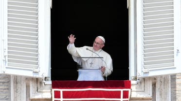 Pope Francis waves at the faithful gathered in St. Peter's at the Vatican during his Sunday Angelus prayer on July 24, 2016. AFP