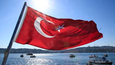 A Turkish flag flies near the Bosporus strait prior to the Bosporus Cross-Continental Swimming Race in Istanbul, Turkey, Sunday, July 24, 2016. (AP)