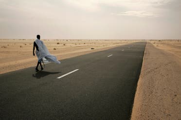 A man walks on the road between Nouahibou and Nouakchott, where three Spanish aid workers were abducted from, December 3, 2009. (Reuters)