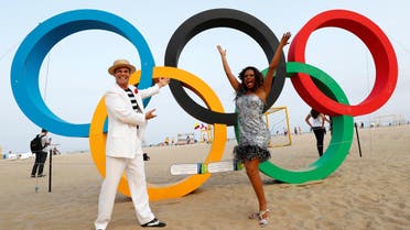 Street performers stand in front of Olympic rings on Copacabana Bean in Rio de Janeiro, less than two weeks before the start of the Rio 2016 Olympic Games, July 25, 2016. REUTERS