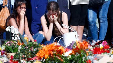 Young women mourning outside the Olympia shopping mall in Munich, Germany July 24, 2016. (Reuters)