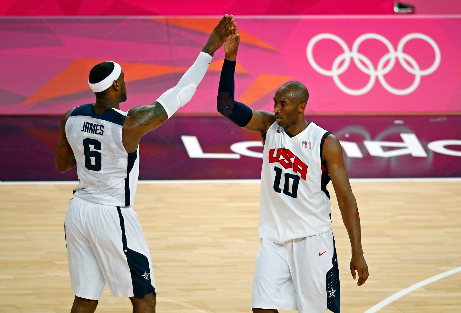 Lebron James (L) and Kobe Bryant both of the U.S. high-five each other during their game against Australia during their men's quarterfinal basketball match at the North Greenwich Arena in London during the London 2012 Olympic Games August 8, 2012. REUTERS/