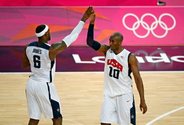 Lebron James (L) and Kobe Bryant both of the U.S. high-five each other during their game against Australia during their men's quarterfinal basketball match at the North Greenwich Arena in London during the London 2012 Olympic Games August 8, 2012. REUTERS/