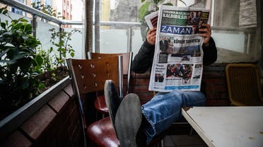 A man reads the first new edition of the Turkish daily newspaper Zaman, which had staunchly opposed the president, now with articles supporting the government since its seizure by authorities last year. (AFP)