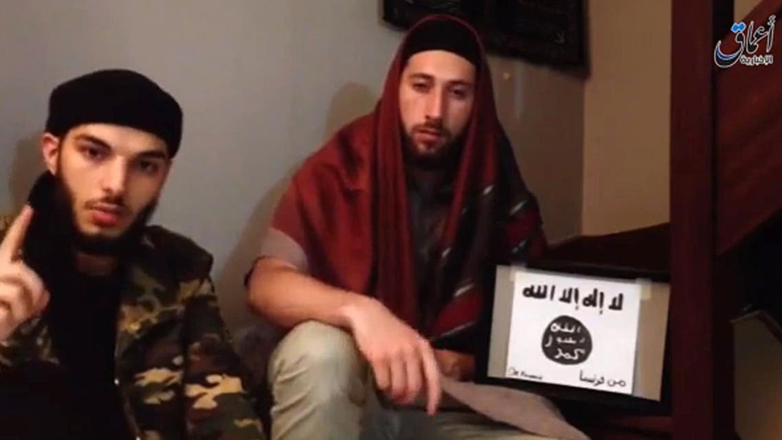 An image grab taken the video shows the two men who identify themselves as ‘Abu Jaleel al-Hanafi’(L) and ‘Ibn Omar’ (R) sitting next to the logo of ISIS while pledging allegiance to Abu Bakr al-Baghdadi. afp