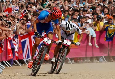 Czech Republic's Jaroslav Kulhavy (L) glances back at Switzerland's Nino Schurter as they approach the finish line during the men's cross-country mountain bike event at Hadleigh Farm at the London 2012 Olympic Games August 12, 2012. Kulhavy won the gold medal in the race, with Schurter taking the silver. (Reuters)