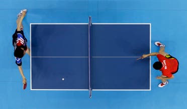 Ma Long of China competes against Ryu Seungmin of South Korea, left, in the men's team table tennis gold medal match at the 2012 Summer Olympics, Wednesday, Aug. 8, 2012, in London. (AP)