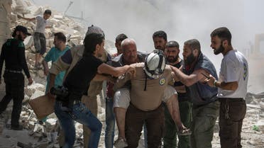 Syrians carry a wounded man away from the rubble of a building that according to the Syrian Observatory for Human Rights was destroyed during a barrel bomb attack by government forces in the opposition-held district of Al-Mashhad near Aleppo on July 26, 2016. Syrian government forces seized a rebel-held neighbourhood on the northwest outskirts of Aleppo, tightening their siege of the opposition-controlled parts of the city, a monitor said. (AFP)